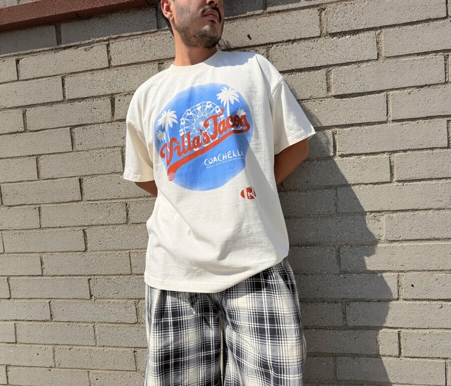 Person wearing Villas Tacos graphic t-shirt with Coachella-inspired design, showcasing LA streetwear style and taco culture.
